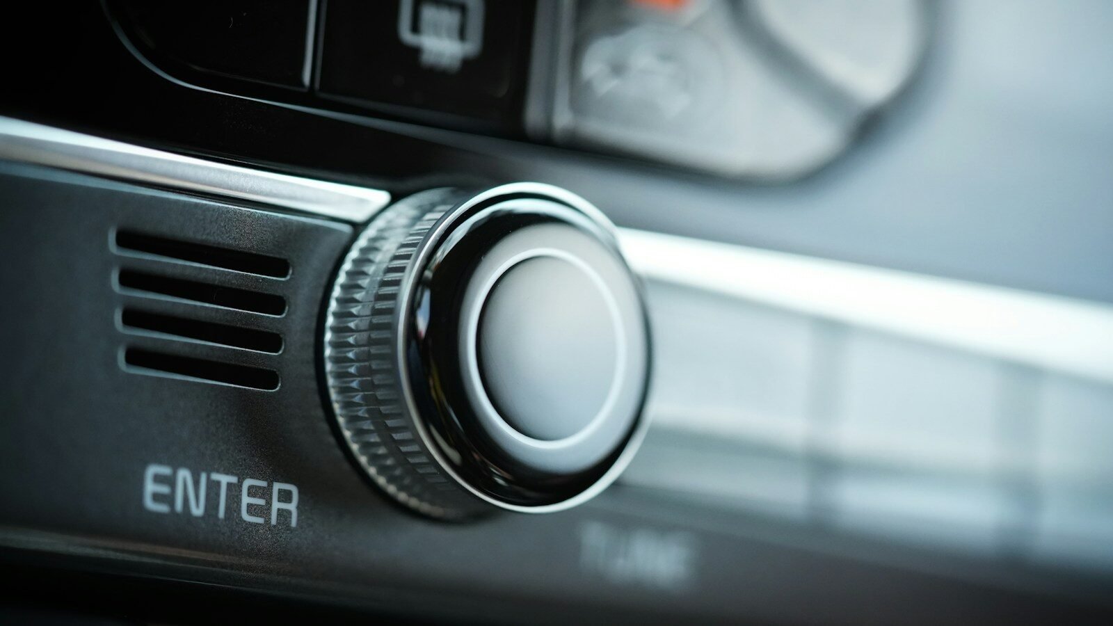 the control panel of a car with a button on it
